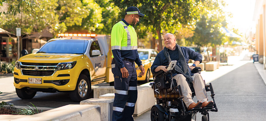 Roadside patrol man helping man in wheelchair