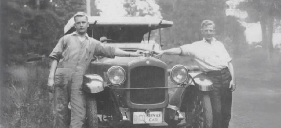 Vintage photo of two patrol officers standing in front of car