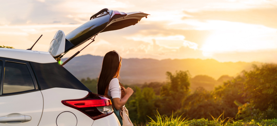 Woman with Rental Car at Mountain Sunrise