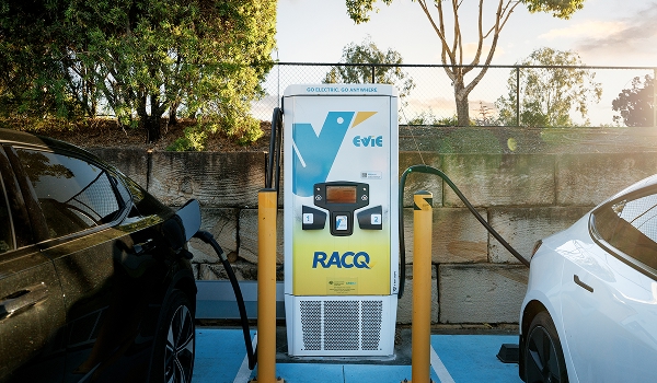 Evie electric vehicle charging station with RACQ branding charging two electric cars