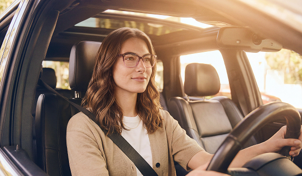 Person driving a vehicle while wearing glasses