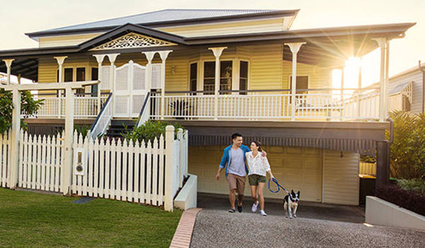 family walking dog outside house
