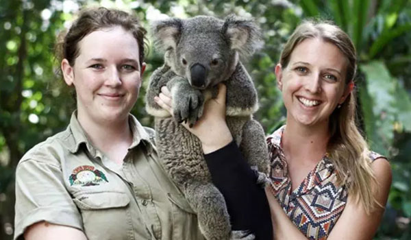 Two girls holding koala