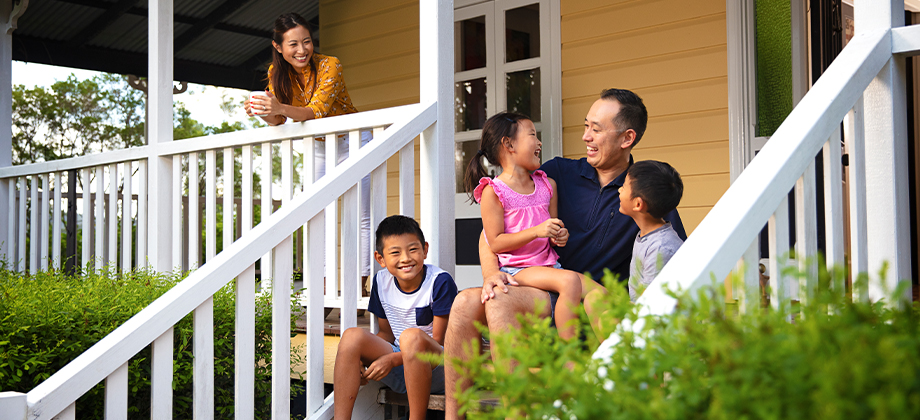family sitting outside house front porch