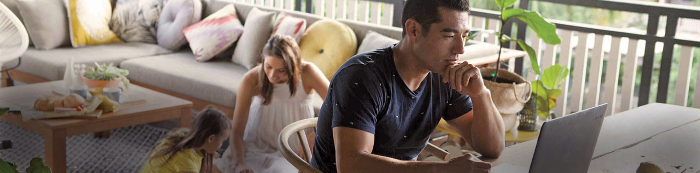 man-on-computer-with-mother-and-daughter-background