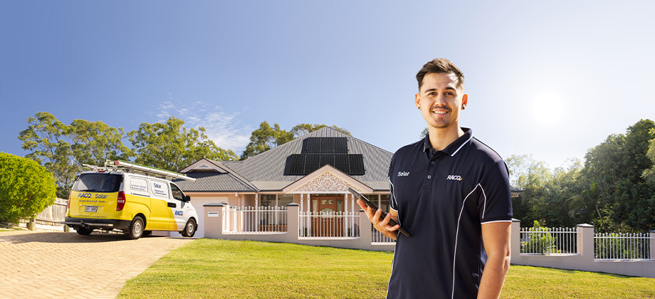 solar mech standing in front of house with racq van and solar panels