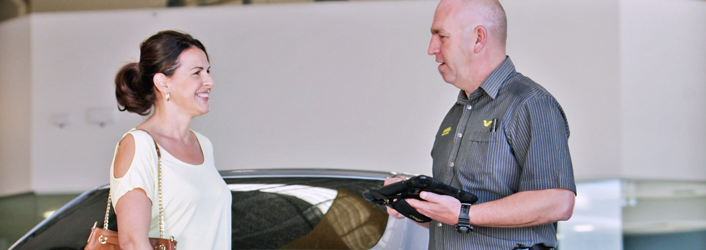 Repairer inspecting car