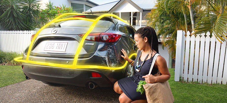 Lady looking at damage on car