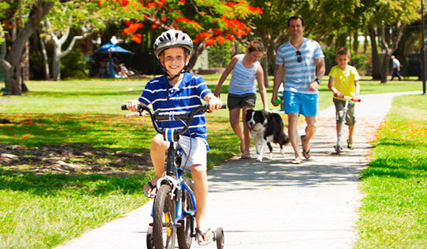 Boy Riding bike with family