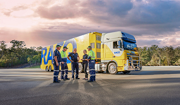 RACQ team in front of truck with sunset