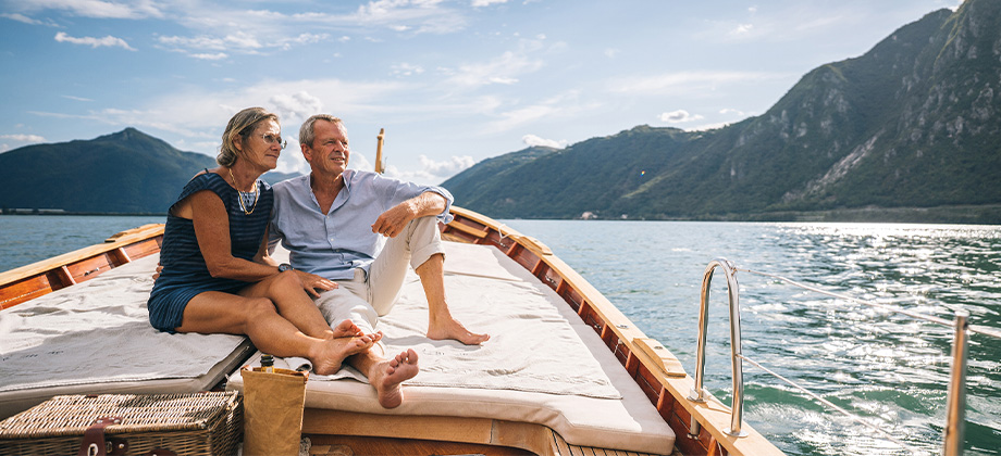 senior couple relaxing on boat on ocean water