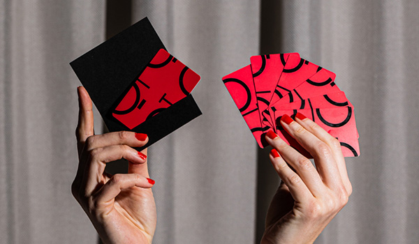 Hands holding QT Hotel and Resorts gift cards