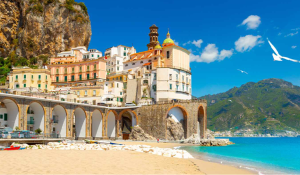 Coastal town of Atrani, Italy with arched road and beach view