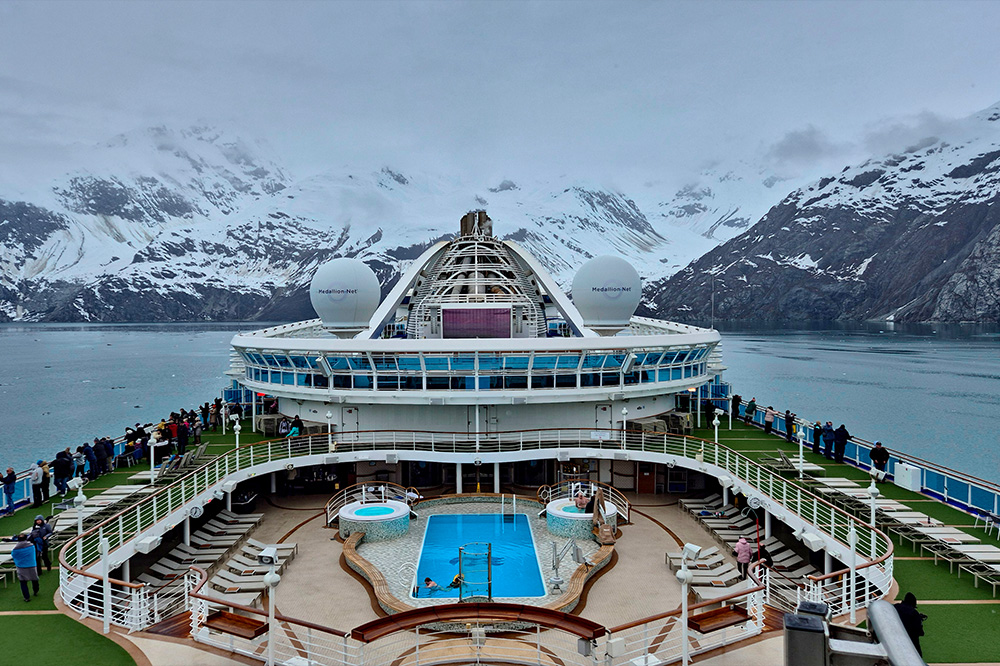 Tourists on a cruise ship looking at the glaciers of Glacier Bay National Park and Preserve in Alask
