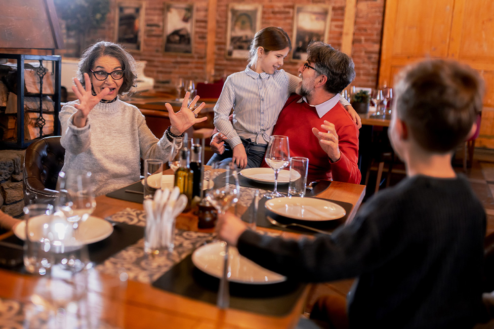 Happy multigenerational family gathering and sharing meal in restaurant 1000x666