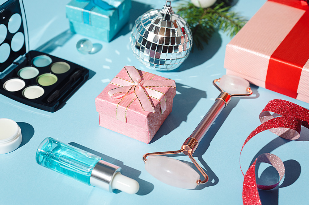 Merry Christmas Happy New Year beauty products gift concept 1000x666