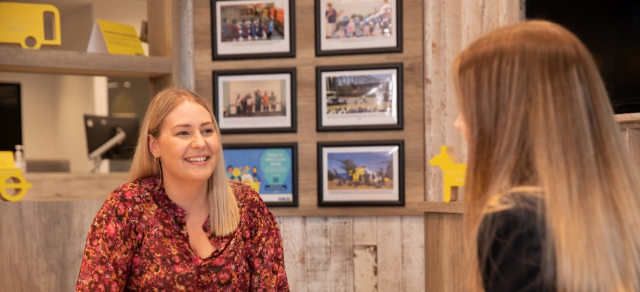 RACQ staff with member in store