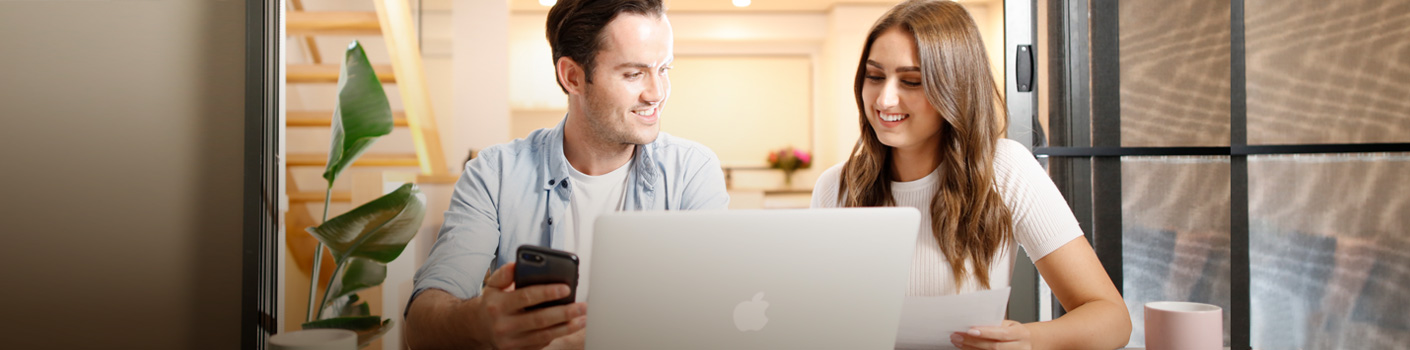 hero-young-couple-looking-laptop