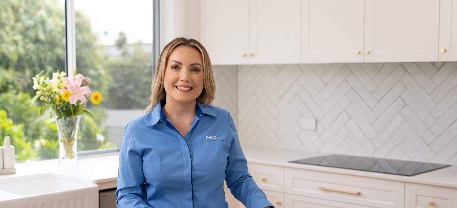 RACQ Bank lender smiling inside kitchen for client consultation