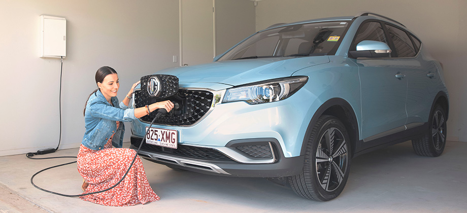 woman charging MG blue triangle 920x420