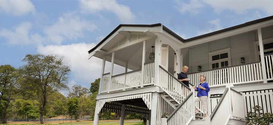 Home owners standing on the front stairs of their home