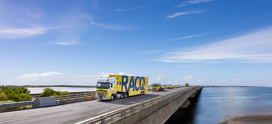 RACQ trucks driving on bridge