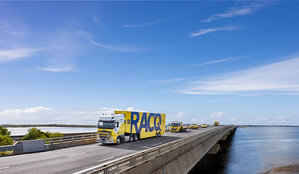 RACQ trucks driving on bridge